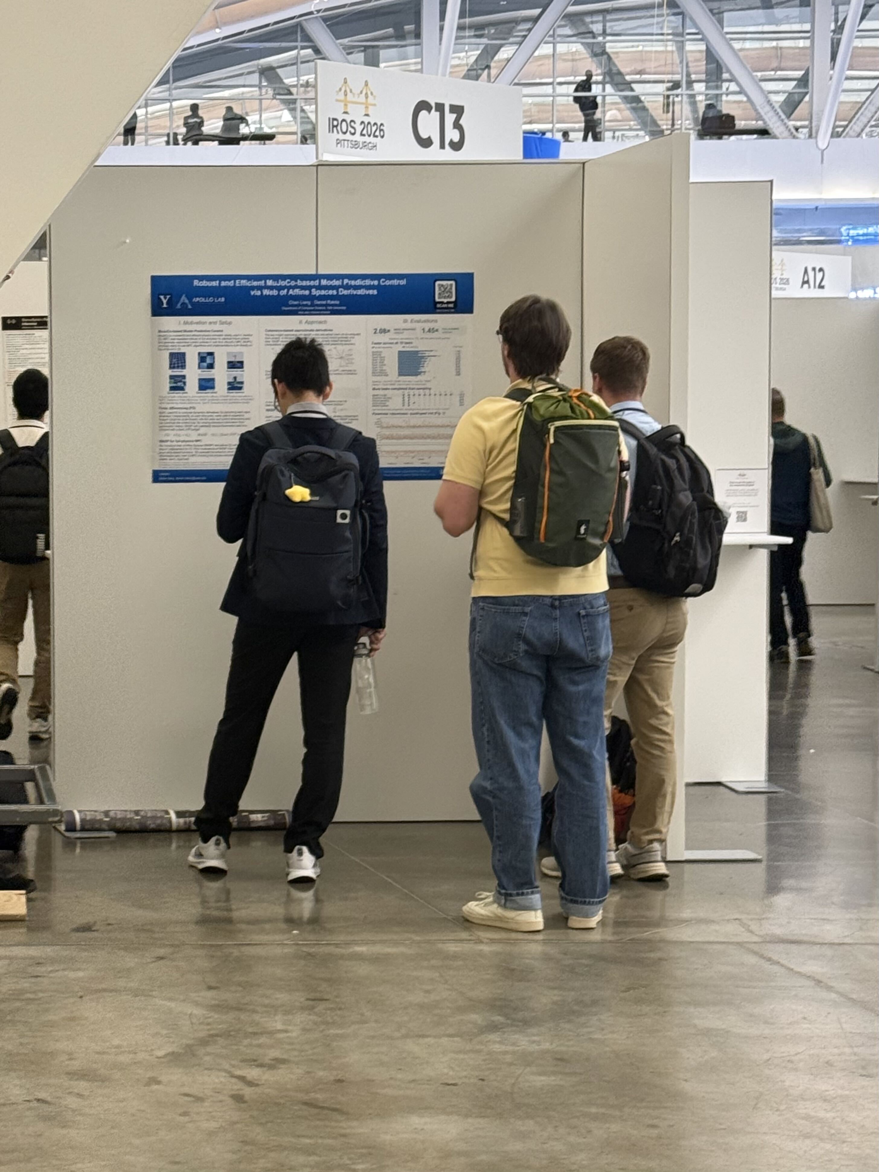 Discussing the model predictive control work during the IROS poster session.